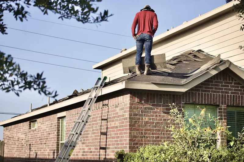 Professional roofer working on a residential roof in Handy Holiday Community